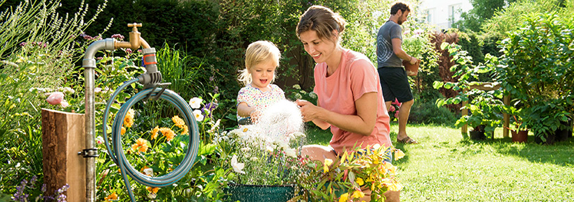 Mutter und Tochter sitzen im Garten.